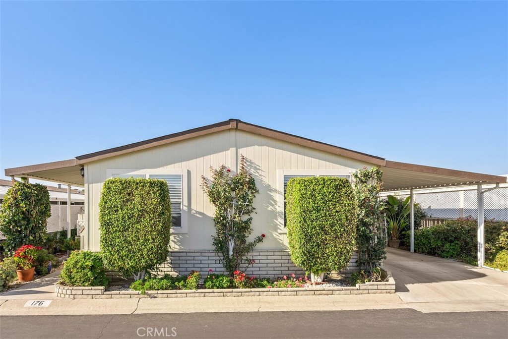 14851 Jeffrey Road, Unit 176 Irvine, CA 92618 - Photo 1 of 30 a front view of a house with garden