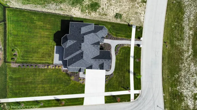 an aerial view of a house with a yard