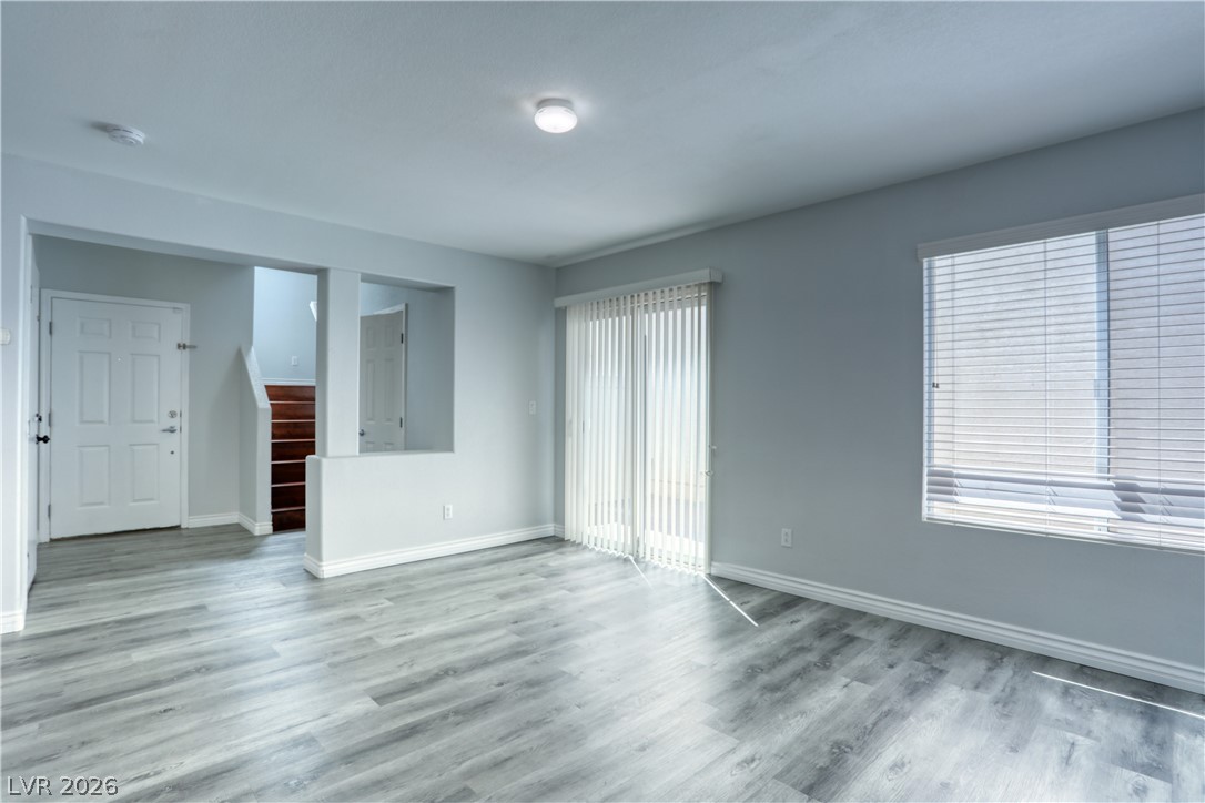 7226 Cestrum Road Las Vegas, NV 89113 - Photo 10 of 28 living room with stairs and light wood-type flooring