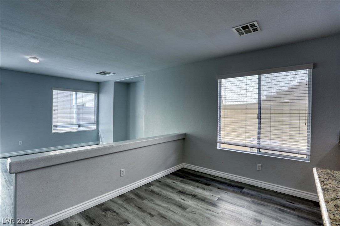 7226 Cestrum Road Las Vegas, NV 89113 - Photo 12 of 28 Room with light wood-style flooring, plenty of natural light, and a textured ceiling