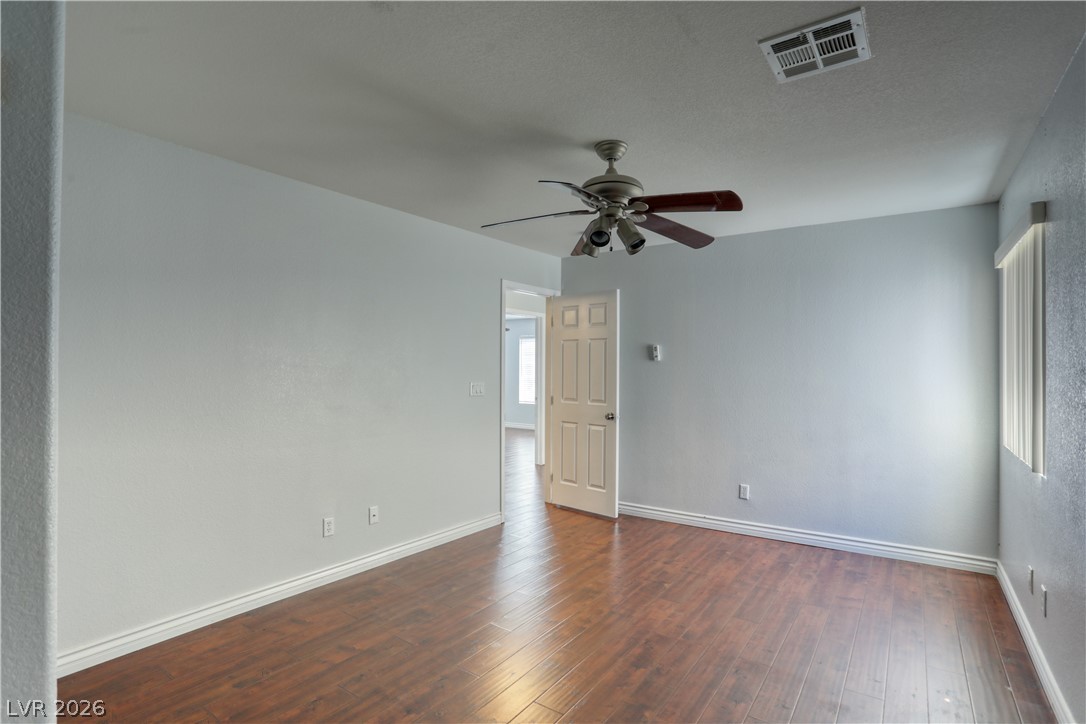 7226 Cestrum Road Las Vegas, NV 89113 - Photo 18 of 28 Sec room featuring a ceiling fan and dark wood-type flooring