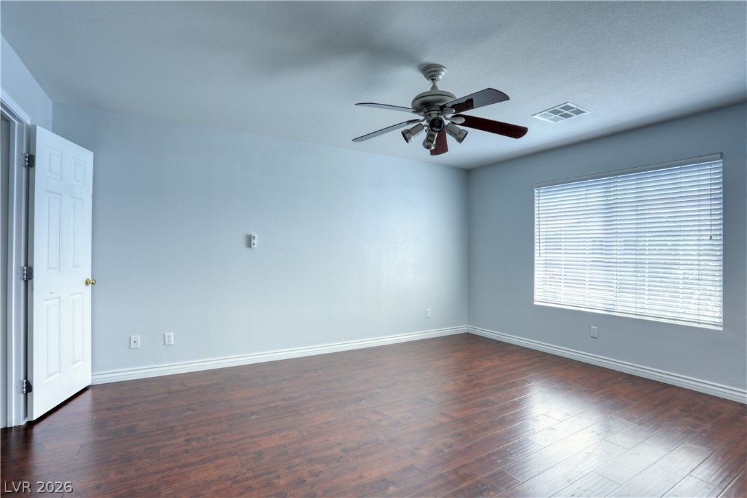 7226 Cestrum Road Las Vegas, NV 89113 - Photo 21 of 28 Primary Bedroom featuring dark wood finished floors and ceiling fan