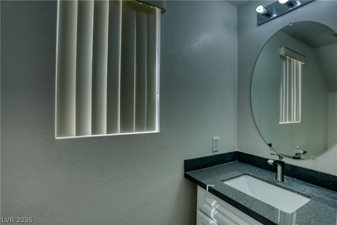 7226 Cestrum Road Las Vegas, NV 89113 - Photo 24 of 28 Bathroom with a textured wall and vanity