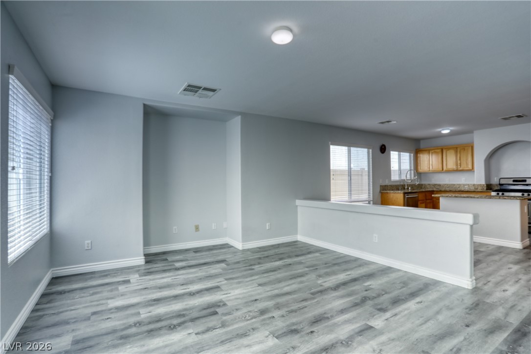 7226 Cestrum Road Las Vegas, NV 89113 - Photo 9 of 28 Unfurnished living room featuring light wood-style flooring and baseboards