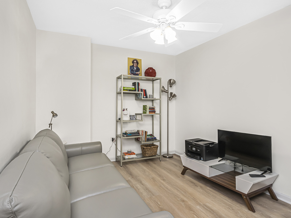 800 Elgin Road, Unit 907 Evanston, IL 60201 - Photo 12 of 17 a living room with furniture and a flat screen tv