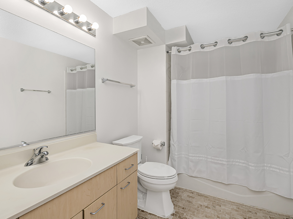 800 Elgin Road, Unit 907 Evanston, IL 60201 - Photo 13 of 17 a bathroom with a sink toilet and shower