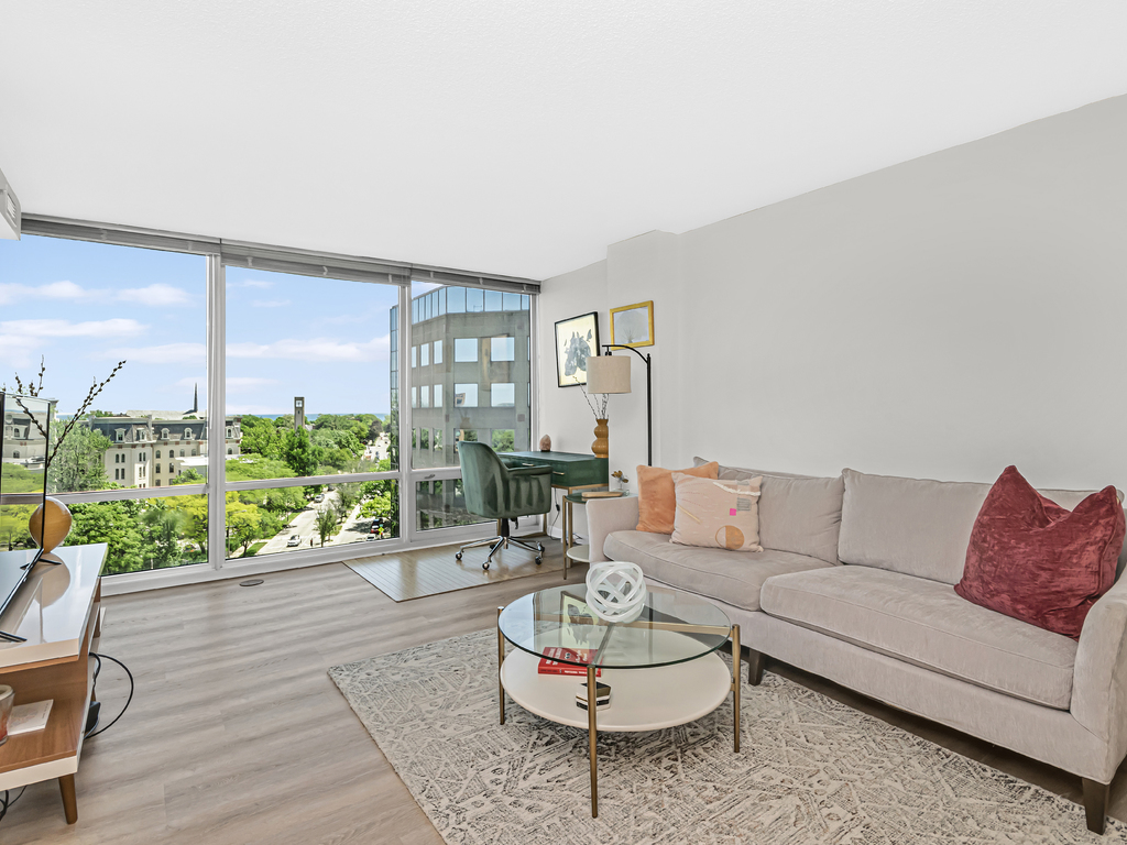 800 Elgin Road, Unit 907 Evanston, IL 60201 - Photo 2 of 17 a living room with furniture and a large window