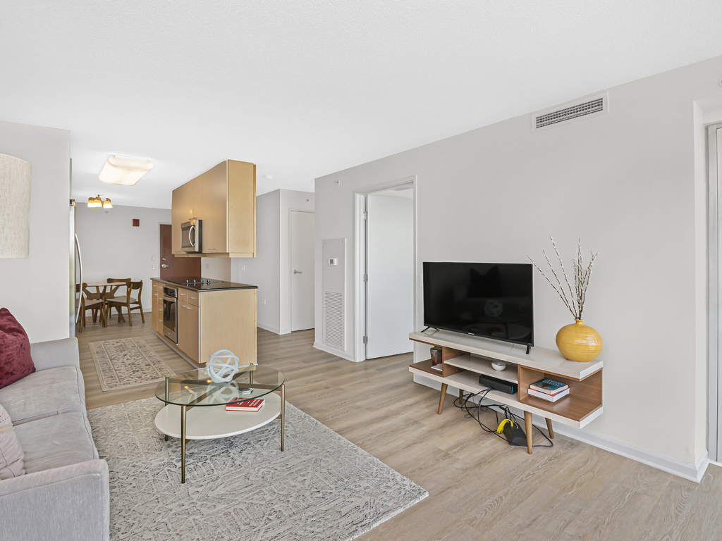 800 Elgin Road, Unit 907 Evanston, IL 60201 - Photo 5 of 17 a living room with furniture and a flat screen tv