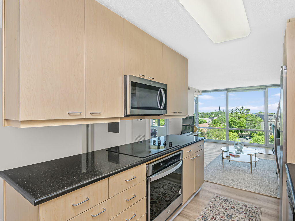 800 Elgin Road, Unit 907 Evanston, IL 60201 - Photo 7 of 17 a kitchen with stainless steel appliances granite countertop a sink and a stove