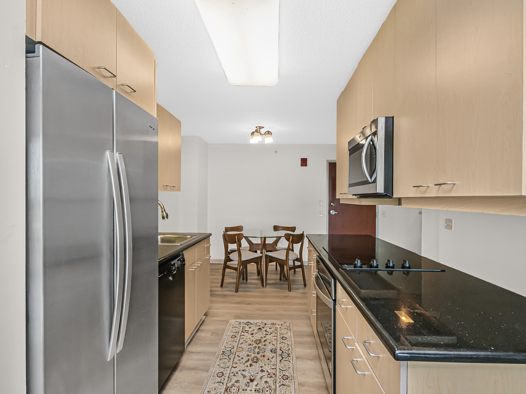 800 Elgin Road, Unit 907 Evanston, IL 60201 - Photo 9 of 17 a kitchen with granite countertop a sink stainless steel appliances and cabinets