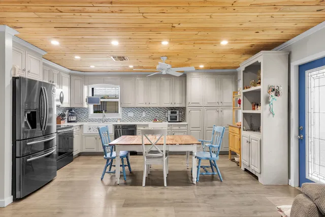 a kitchen with cabinets and stainless steel appliances