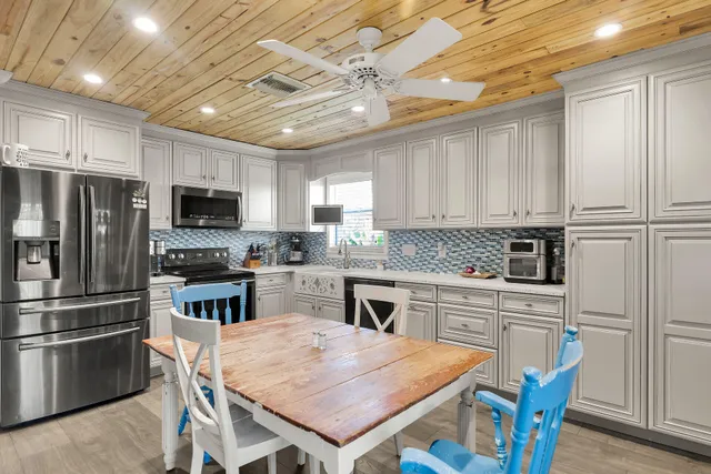 a kitchen with a refrigerator a stove top oven a sink and dishwasher