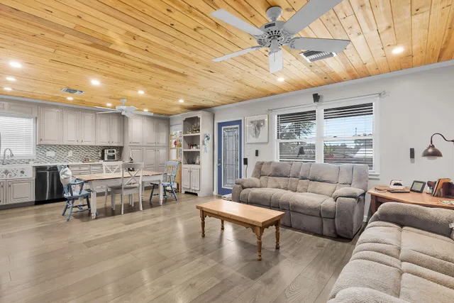 a living room with furniture and kitchen view