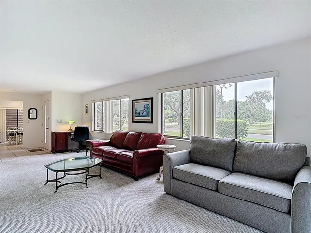 a white refrigerator freezer and a stove sitting inside of a kitchen with granite countertop white stainless steel appliances