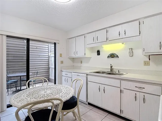 a kitchen with a stove a sink and a microwave