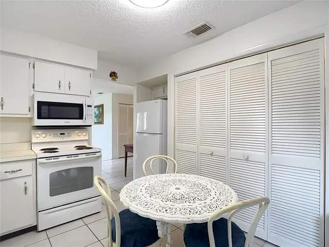 a view of a house with many windows and a yard