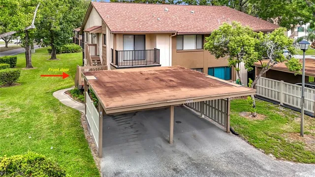 a view of a house with a big yard and potted plants