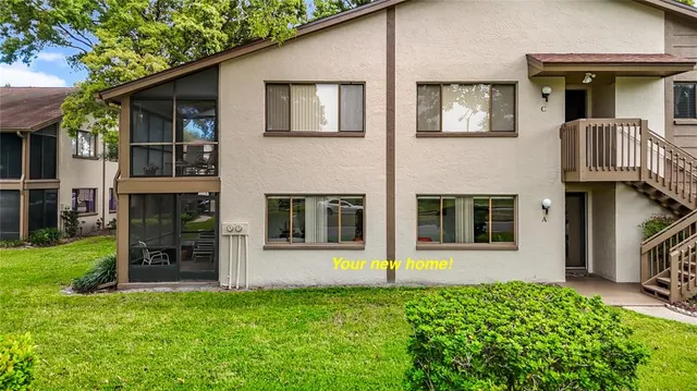 a view of a house with a yard and plants