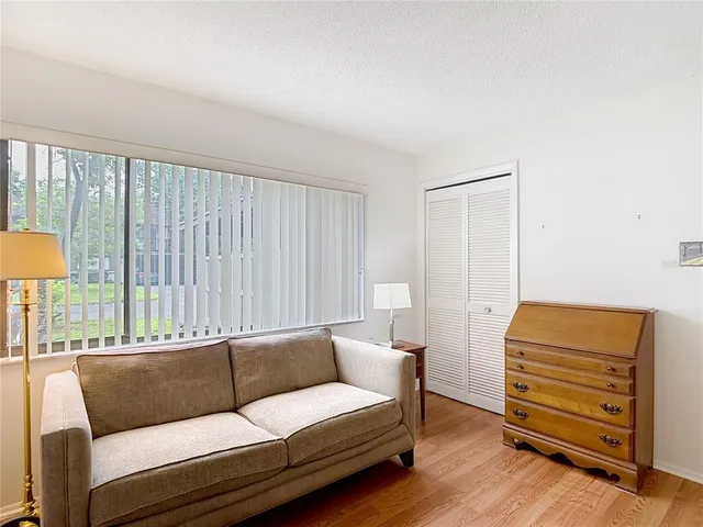 a view of a patio with a table and chairs and a barbeque