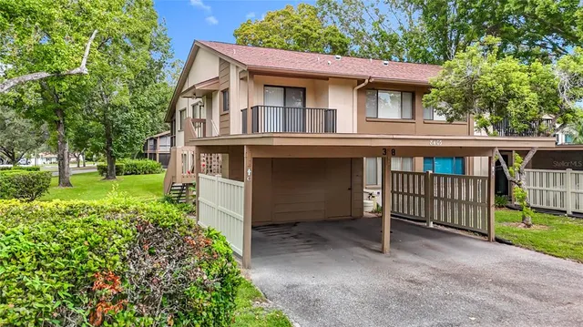 a view of a fountain in a yard with palm trees