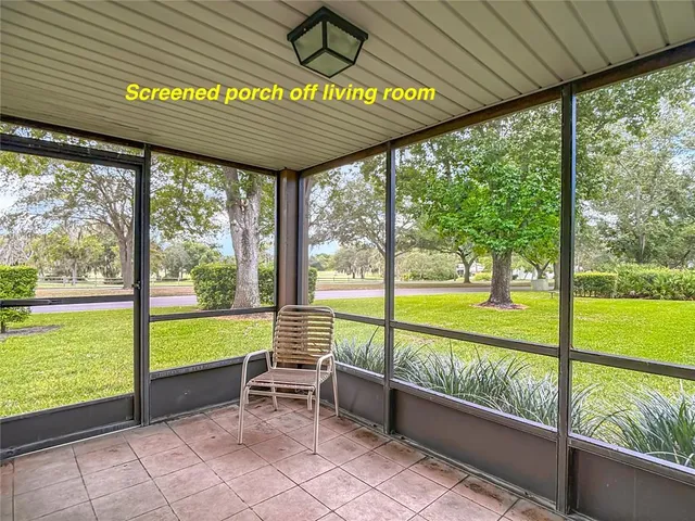 a view of swimming pool with outdoor seating and a garden