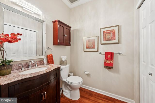 a bathroom with a granite countertop sink mirror and vanity