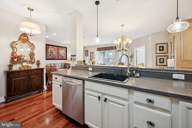 a kitchen with sink cabinets and wooden floor