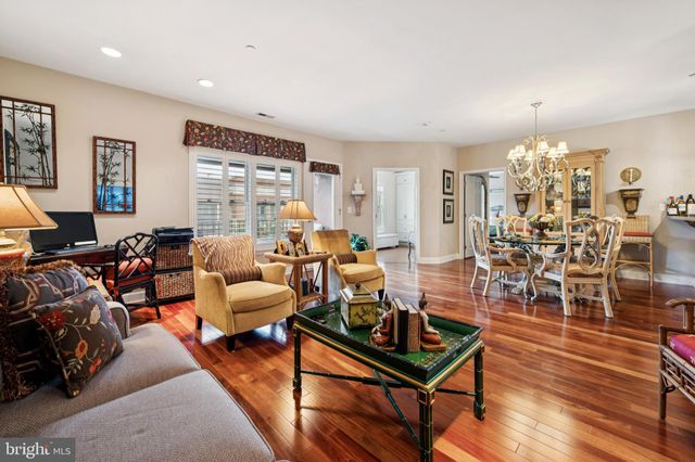 a living room with lots of furniture and a large window