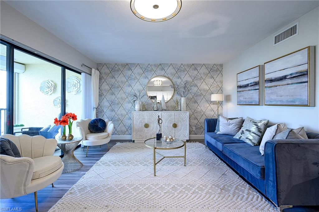 586 Beachwalk Circle, Unit O205 Naples, FL 34108 - Photo 11 of 36 a living room with furniture and a large window