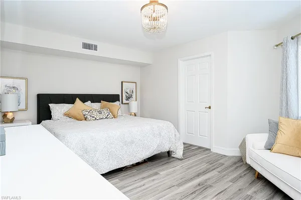 a bedroom with a bed and a couch