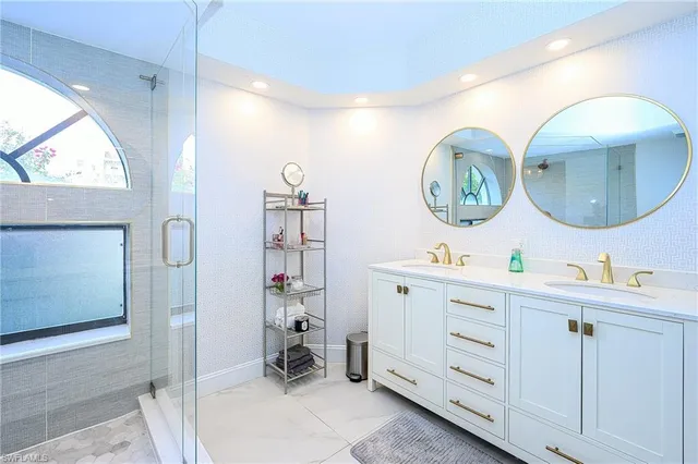 a room with two mirror and a clock on the wall