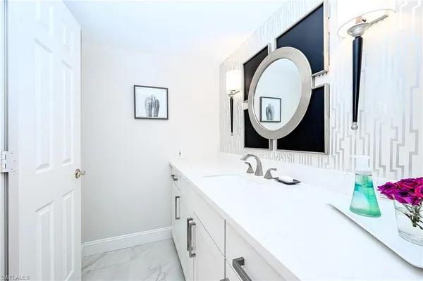 a bathroom with a sink and a mirror