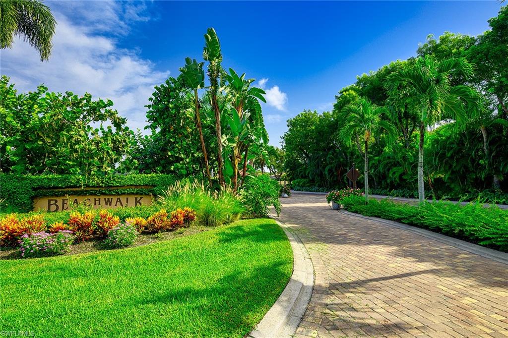 586 Beachwalk Circle, Unit O205 Naples, FL 34108 - Photo 25 of 36 a view of a garden with a lake view