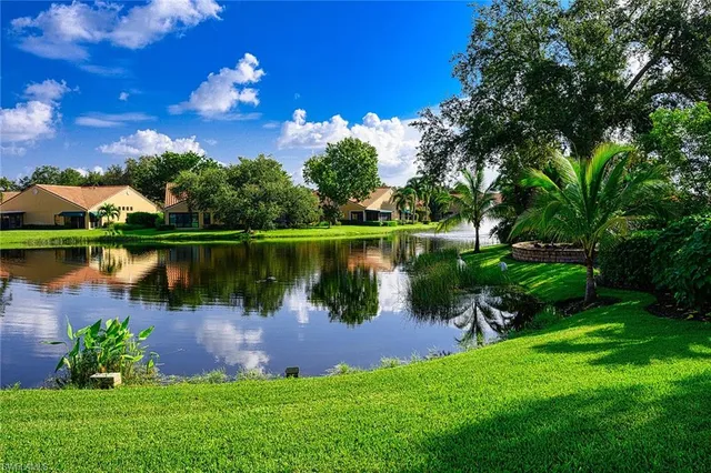 a view of a lake with a garden and houses