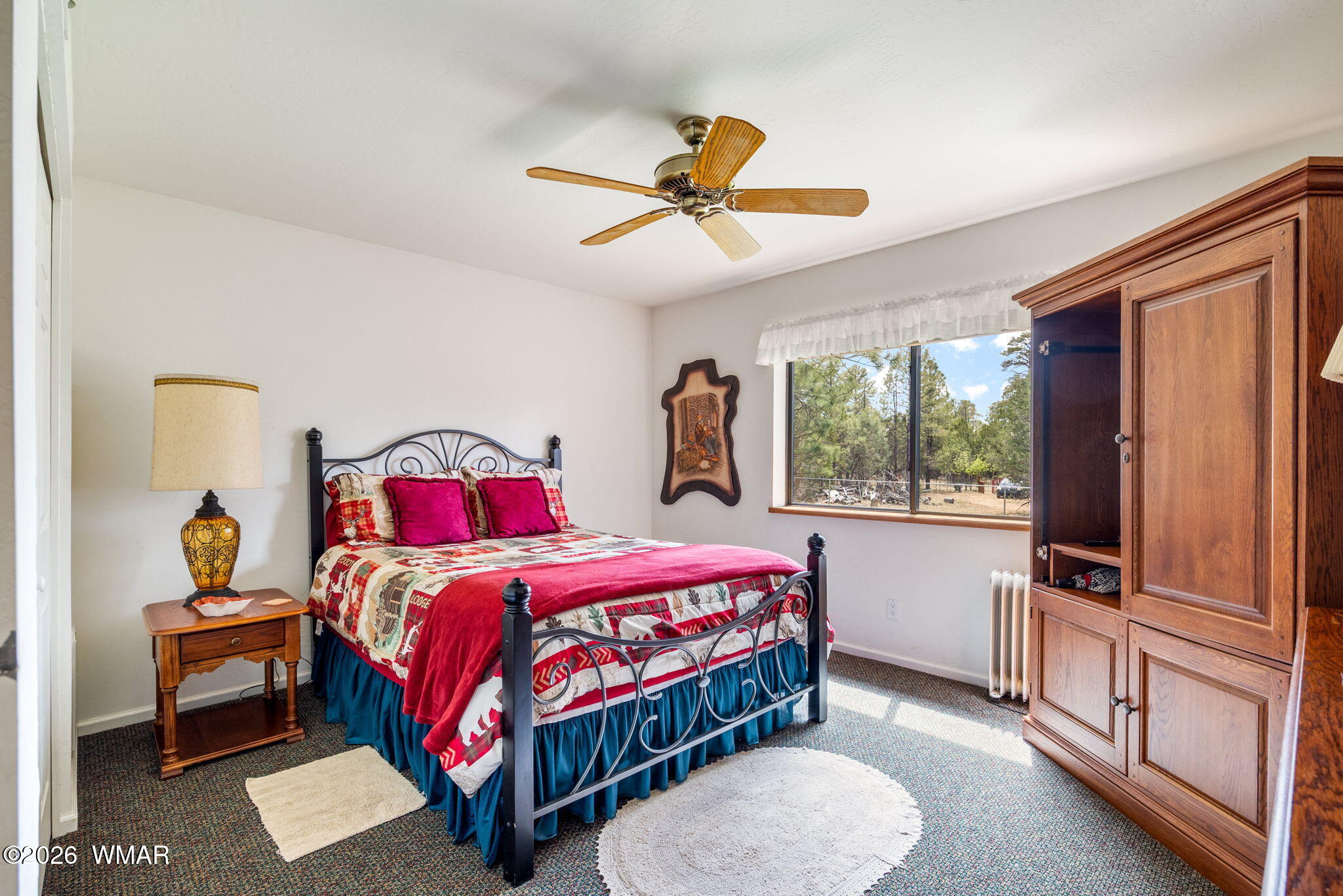 2922 Pine Rim Road Overgaard, AZ 85933 - Photo 28 of 58 a bedroom with a bed and a flat screen tv