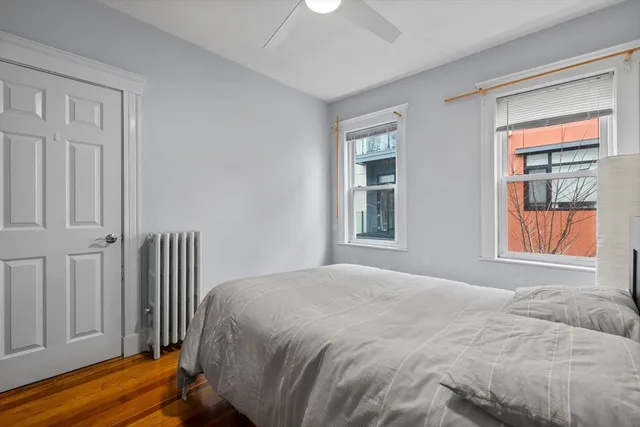 a bedroom with a bed next to a window