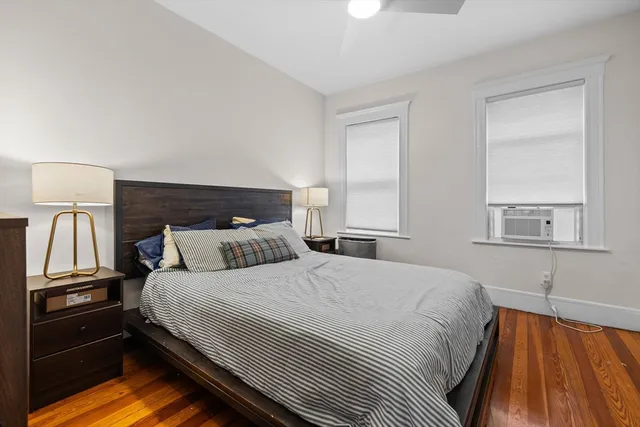 a bedroom with a bed and a night stand