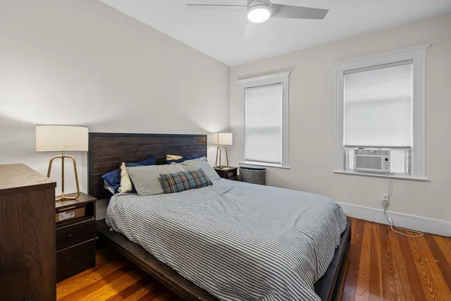 a bedroom with a bed and a night stand