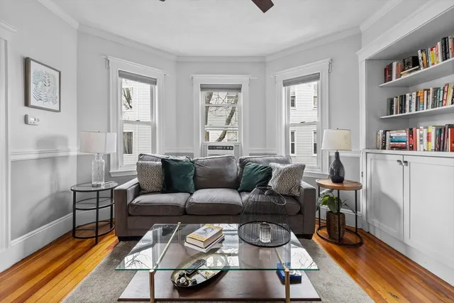 a living room with furniture and a book shelf