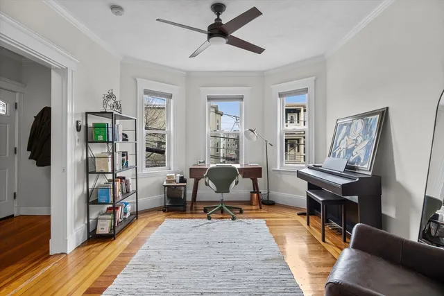 a living room with furniture a rug and a window