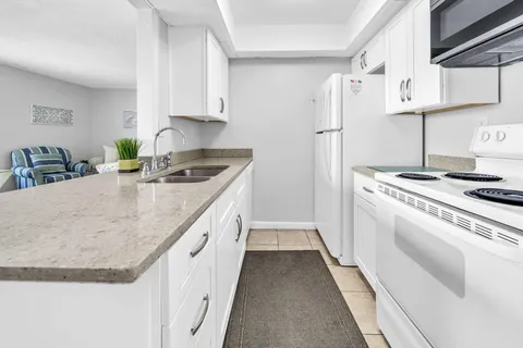 a kitchen with a stove and a refrigerator
