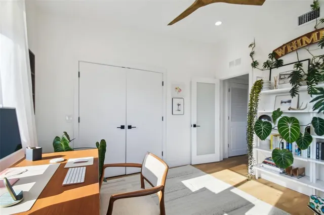 a reading room with furniture and a potted plant