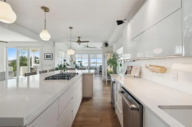 a large kitchen with lots of counter space and stainless steel appliances