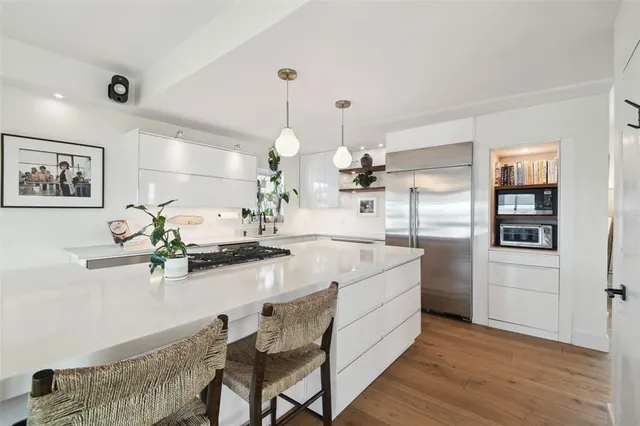a large kitchen with a table and chairs