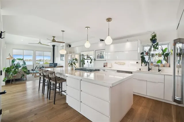 a kitchen with white cabinets and sink