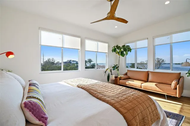 a bedroom with furniture and a large window