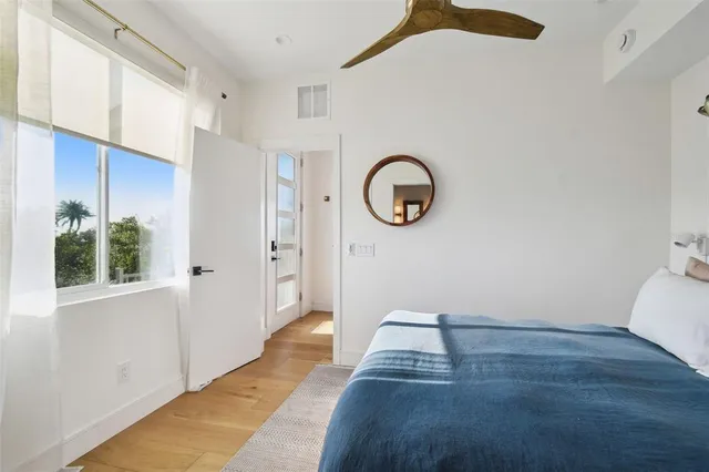 a view of a livingroom with wooden floor and a window