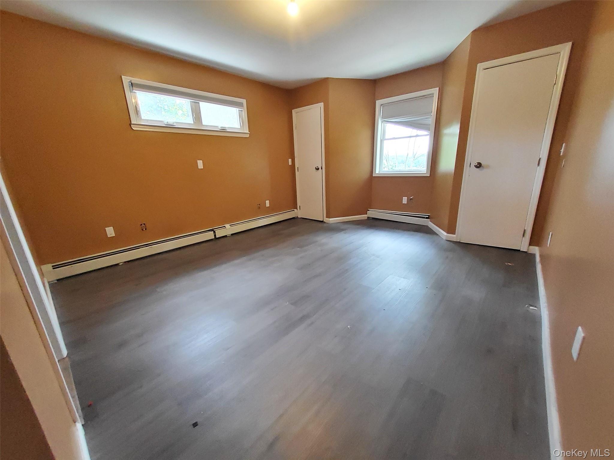 469 Hillside Road Monroe, NY 10950 - Photo 10 of 20 an empty room with wooden floor and windows