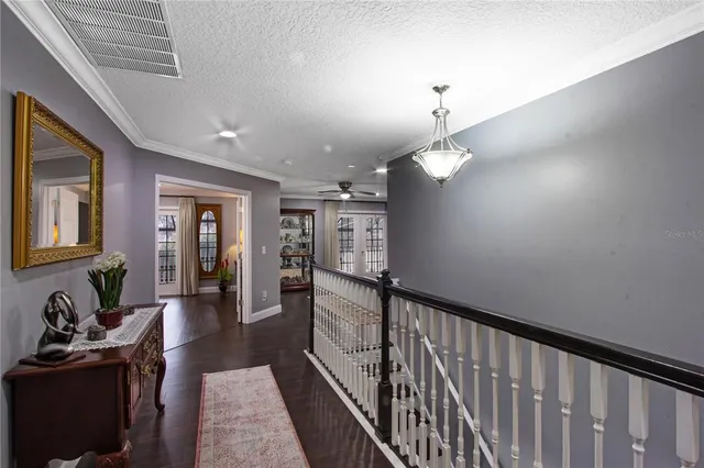 a kitchen with a refrigerator a stove a sink a dining table and chairs