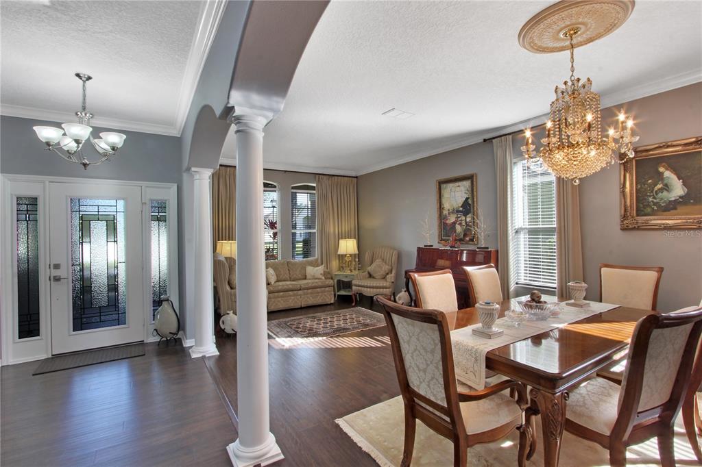 5536 Ansley Way Mount Dora, FL 32757 - Photo 27 of 49 a view of a dining room with furniture wooden floor and chandelier